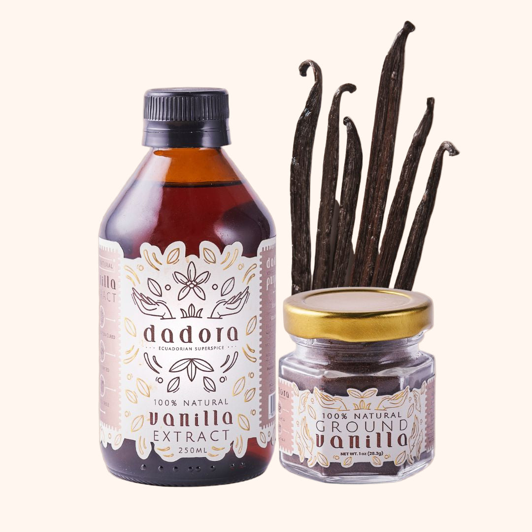 A bottle of Dadora vanilla extract next to a jar of ground vanilla powder and a selection of vanilla beans.